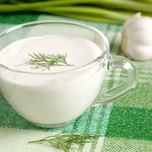 Creamy Alfredo sauce drizzled over pasta, with a sprinkle of Parmesan cheese and fresh herbs.