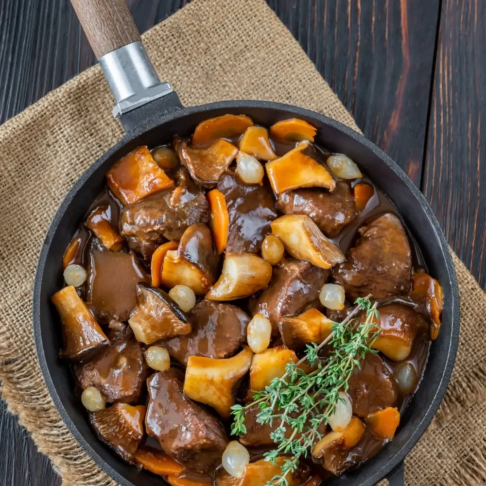 A hearty bowl of beef bourguignon, rich with tender beef, vegetables, and a flavorful sauce.