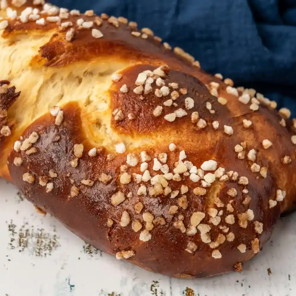 Soft, golden-brown brioche loaf with a light and airy texture, sliced to show its buttery crumb.