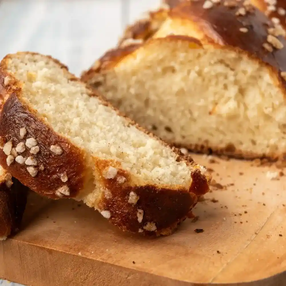 Soft, golden-brown brioche loaf with a light and airy texture, sliced to show its buttery crumb.