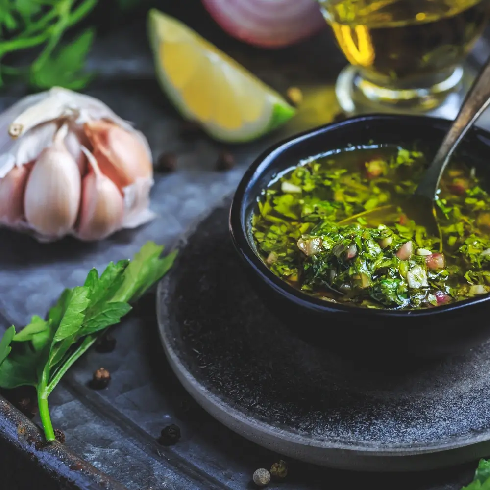 Fresh chimichurri sauce served in a small bowl, with vibrant herbs and a hint of acidity.