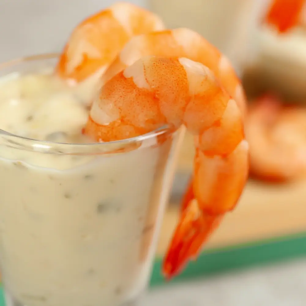 A bowl of creamy homemade tartar sauce, featuring chopped pickles, fresh herbs, and a tangy, flavorful base.