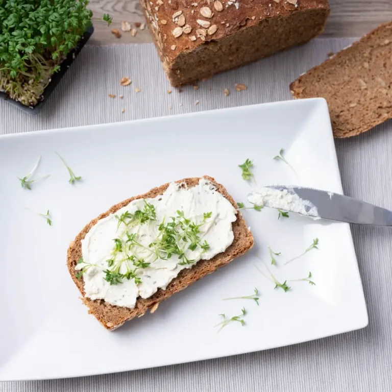 A slice of homemade cottage cheese bread, with a soft, fluffy texture and a golden-brown crust.