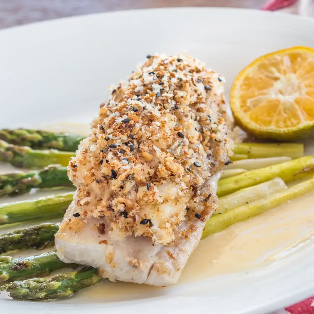 A perfectly pan seared mahi mahi fillet, golden and crispy on the outside, tender on the inside, served with a side of vegetables.