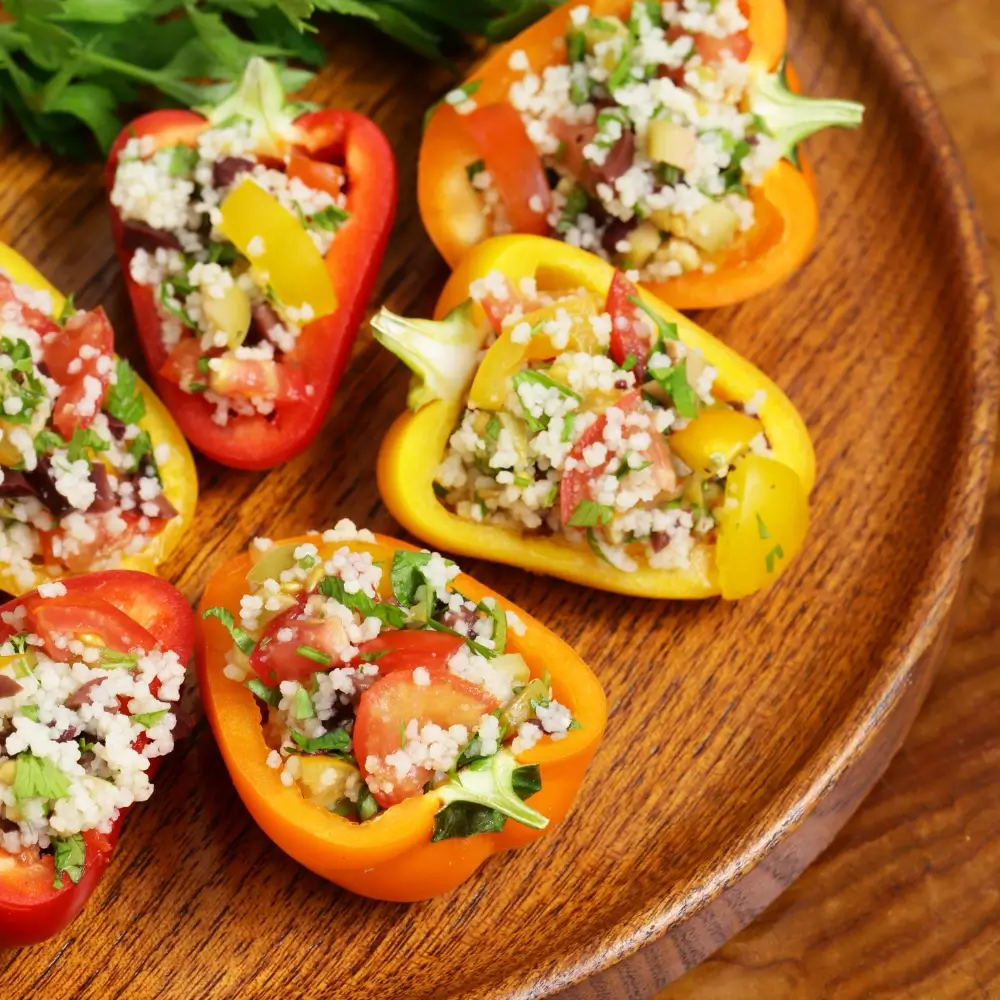 A plate of colorful stuffed bell peppers, filled with a savory mixture of rice, vegetables, and seasonings.