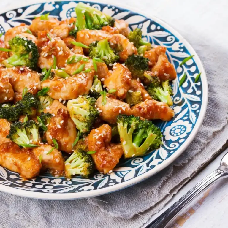 A bowl of fresh chicken salad, featuring tender chicken, crisp vegetables, and a creamy dressing.